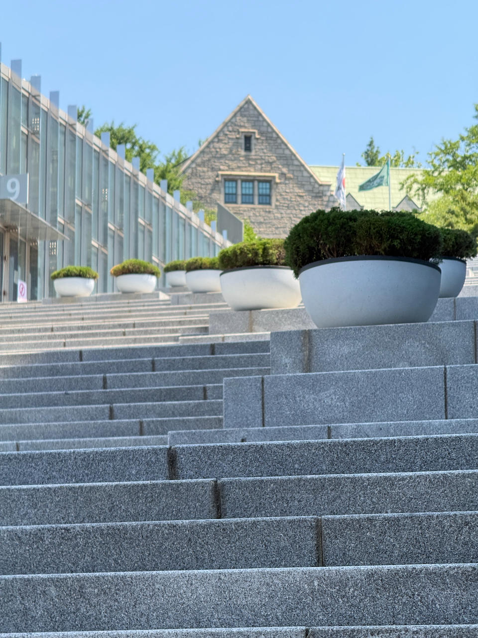 梨花女大下沉式台阶，砖墙背后是 Ewha Campus Complex 的折纸形建筑 10:43:41